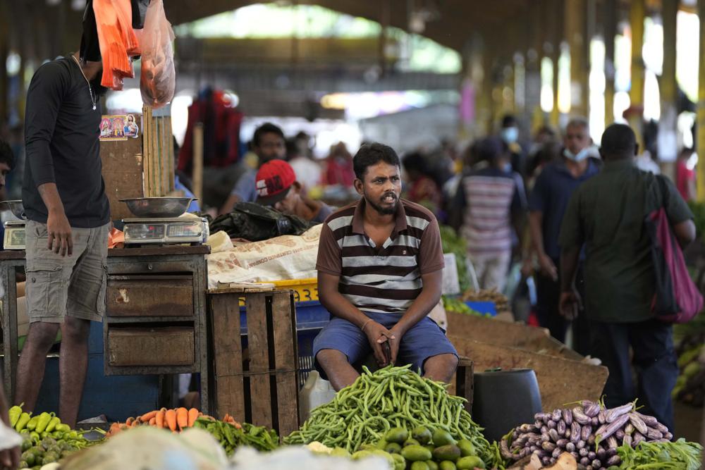 FILE – A vender waits for customers at a vegetable market place in Colombo, Sri Lanka, Friday, June 10, 2022. The International Monetary Fund said Thursday, Sept. 1, 2022, it has reached a staff-level agreement with Sri Lanka to provide $ 2.9 billion over four years to help salvage the country from its worst economic crisis in recent memory. (AP Photo/Eranga Jayawardena, File)
