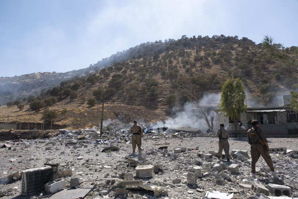 Members of exiled Komala Party inspect aftermath of bombing in the village of Zrgoiz, near Sulaimaniyah, Iraq, where the bases of several Iranian opposition groups are located, Wednesday, Sept. 28, 2022. An Iranian drone bombing campaign targeting the bases of an Iranian-Kurdish opposition group in northern Iraq has killed nd wounded dozens. (AP PhotoAla Hoshyar, Metrography)