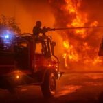 This photo provided by the SDIS33 fire brigade shows firemen trying to pull off a wildfire near the village of Saumos, southwestern France, Monday Sept.12, 2022. New wildfires raging in southwestern France have torn through over 1,000 hectares of land and forced the evacuation of residents amid record temperatures for September. Fires that began to rage Monday caused the evacuation of over 500 in the Gironde region. (SDIS33 via AP)