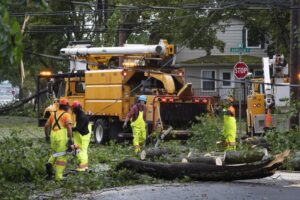 Workers clear fallen trees and downed wires from damage caused by post tropical storm Fiona in Halifax on Saturday, Sept. 24, 2022. Strong rains and winds lashed the Atlantic Canada region as Fiona closed in early Saturday as a big, powerful post-tropical cyclone, and Canadian forecasters warned it could be one of the most severe storms in the country’s history. (Darren Calabrese /The Canadian Press via AP)