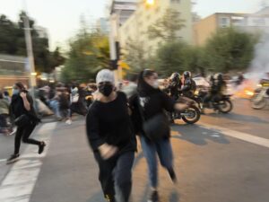 In this Monday, Sept. 19, 2022, photo taken by an individual not employed by the Associated Press and obtained by the AP outside Iran, women run away from anti-riot police during a protest of the death of a young woman who had been detained for violating the country’s conservative dress code, in downtown Tehran, Iran. (AP Photo)