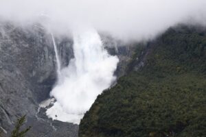A glacier is pictured calving into the river, in Queulat National Park, in Aysen, Chile September 9, 2022. Courtesy Surreal Travel/Handout via REUTERS