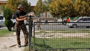 A Taliban fighter stands guard in front of the embassy after the blast