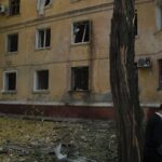 A man walks past a damaged building after a Russian attack in Kramatorsk, Ukraine, Thursday, Sept. 29, 2022. (AP Photo/Leo Correa)
