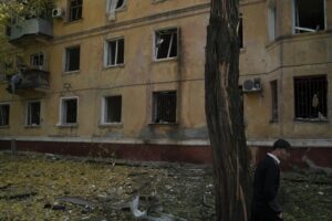 A man walks past a damaged building after a Russian attack in Kramatorsk, Ukraine, Thursday, Sept. 29, 2022. (AP Photo/Leo Correa)