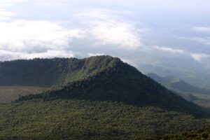 FILE – This Dec. 11, 2016, photo shows the Virunga National Park, taken from the rim of the crater of the Nyiragongo volcano and looking over the crater of another, extinct volcano, in North Kivu Province, in Congo. The auctioning of oil and gas blocks in Congo has stirred resistance and concern among local Indigenous communities worried about damage to their homes and large swaths of forest, according to a report released Thursday, Sept. 28, by several environmental groups. (Juergen Baetz/dpa via AP, File)