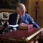 In this photo Sept. 11, 2022, taken Britain’s King Charles III carries out official government duties from his red box in the Eighteenth Century Room at Buckingham Palace, London. (Victoria Jones/PA via AP)