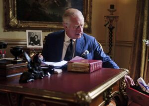 In this photo Sept. 11, 2022, taken Britain’s King Charles III carries out official government duties from his red box in the Eighteenth Century Room at Buckingham Palace, London. (Victoria Jones/PA via AP)