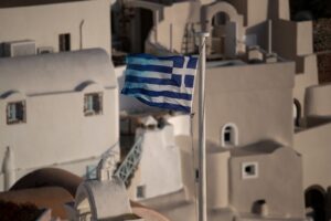 Greek national flag flutters in Oia, following the coronavirus disease (COVID-19) outbreak, on the island of Santorini, Greece, May 6, 2020. REUTERS/Alkis Konstantinidis
