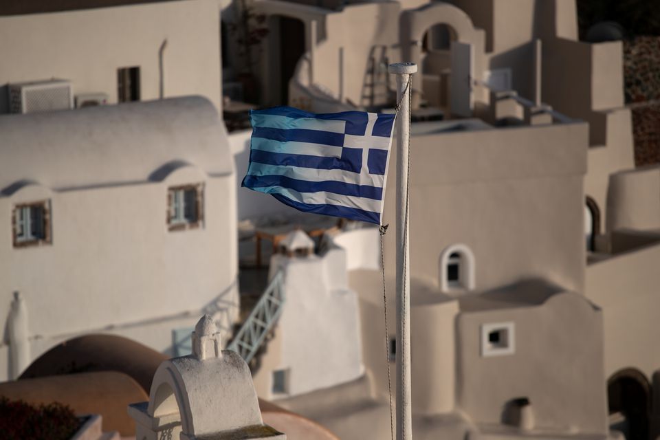 Greek national flag flutters in Oia, following the coronavirus disease (COVID-19) outbreak, on the island of Santorini, Greece, May 6, 2020. REUTERS/Alkis Konstantinidis