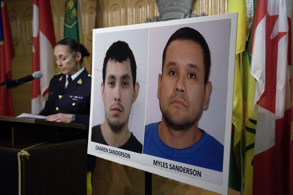 Assistant Commissioner Rhonda Blackmore speaks next to images of Damien Sanderson and Myles Sanderson during a press conference at the Royal Canadian Mounted Police “F” Division headquarters in Regina, Saskatchewan, on Sunday, Sept. 4, 2022. Police said the pair allegedly stabbed and killed multiple people in various locations between the James Smith Cree Nation and in the village of Weldon, northeast of Saskatoon, on Sunday morning, and are presently at large. (Michael Bell/The Canadian Press via AP)
