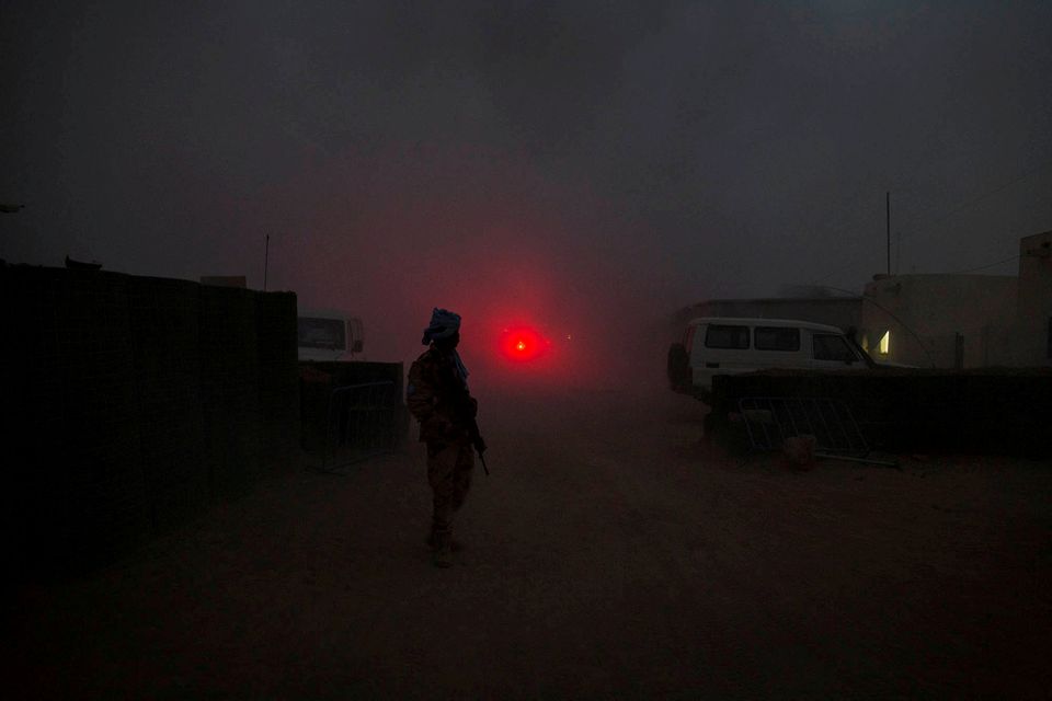 A United Nations peacekeeper secures the MINUSMA base after a mortar attack in Kidal Mali. MINUSMA/Sylvain Liechti handout via REUTERS
