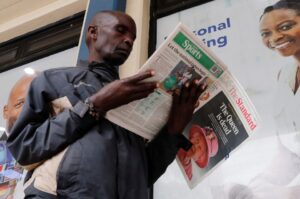 A man reads a newspaper reporting on the death of Queen Elizabeth, Britain’s longest-reigning monarch, in Nairobi, Kenya, September 9, 2022. REUTERS/Thomas Mukoya