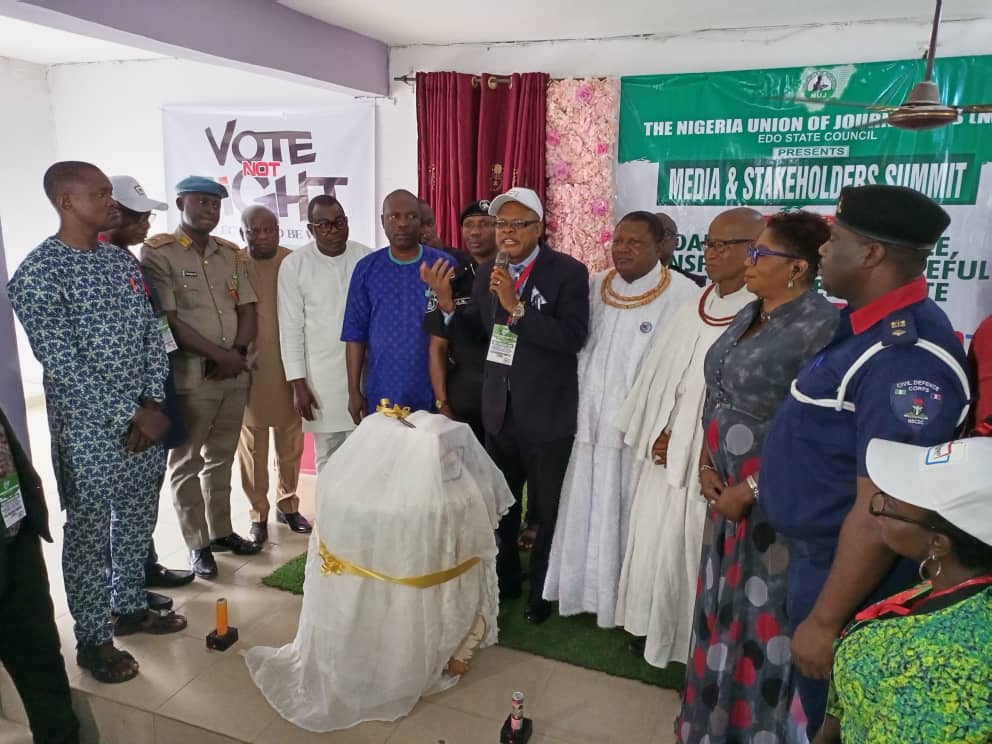 Mr Festus Alenkhe flanked by dignitaries during the programme in Benin City