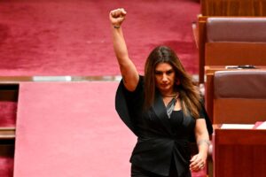 Indigenous Australian parliamentarian Lidia Thorpe raises her fist during her swearing-in ceremony in the Senate chamber at Parliament House in Canberra, Australia, August 1, 2022. AAP Image/Lukas Coch via REUTERS