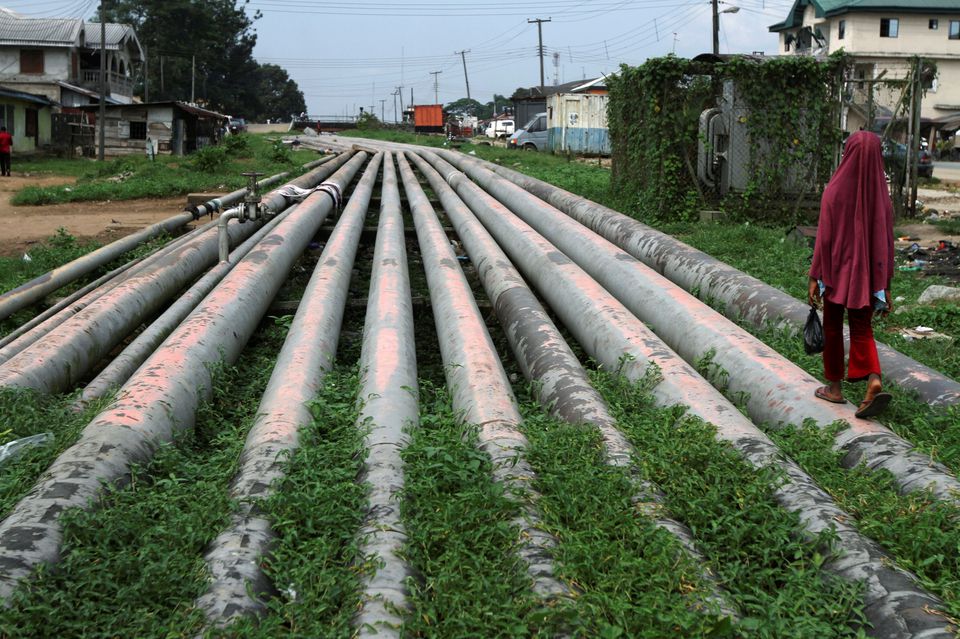 A girl walks on a gas pipeline running through Okrika community near Nigeria’s oil hub city of Port Harcourt December 4, 2012. REUTERS/Akintunde Akinleye/File Photo