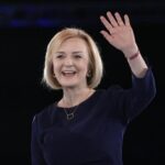 Liz Truss waves on stage after a Conservative leadership election hustings at Wembley Arena in London, Wednesday, Aug. 31, 2022. Britain’s Prime Minister Boris Johnson announced his resignation in early July. His Conservative Party is set to announce his successor on Monday. (AP Photo/Kirsty Wigglesworth)