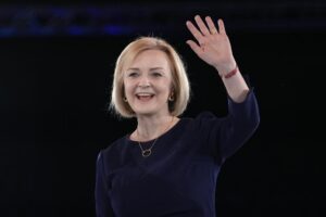 Liz Truss waves on stage after a Conservative leadership election hustings at Wembley Arena in London, Wednesday, Aug. 31, 2022. Britain’s Prime Minister Boris Johnson announced his resignation in early July. His Conservative Party is set to announce his successor on Monday. (AP Photo/Kirsty Wigglesworth)