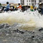 Traffic moves as water is pumped out of an inundated residential area following torrential rains in Bengaluru, India, September 7, 2022. REUTERS/Samuel Rajkumar
