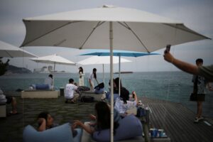 People enjoy themselves at a cafe at Imrang beach as Kori Nuclear Power Plant is seen in the background in Busan, South Korea, August 19, 2022. REUTERS/Kim Hong-Ji