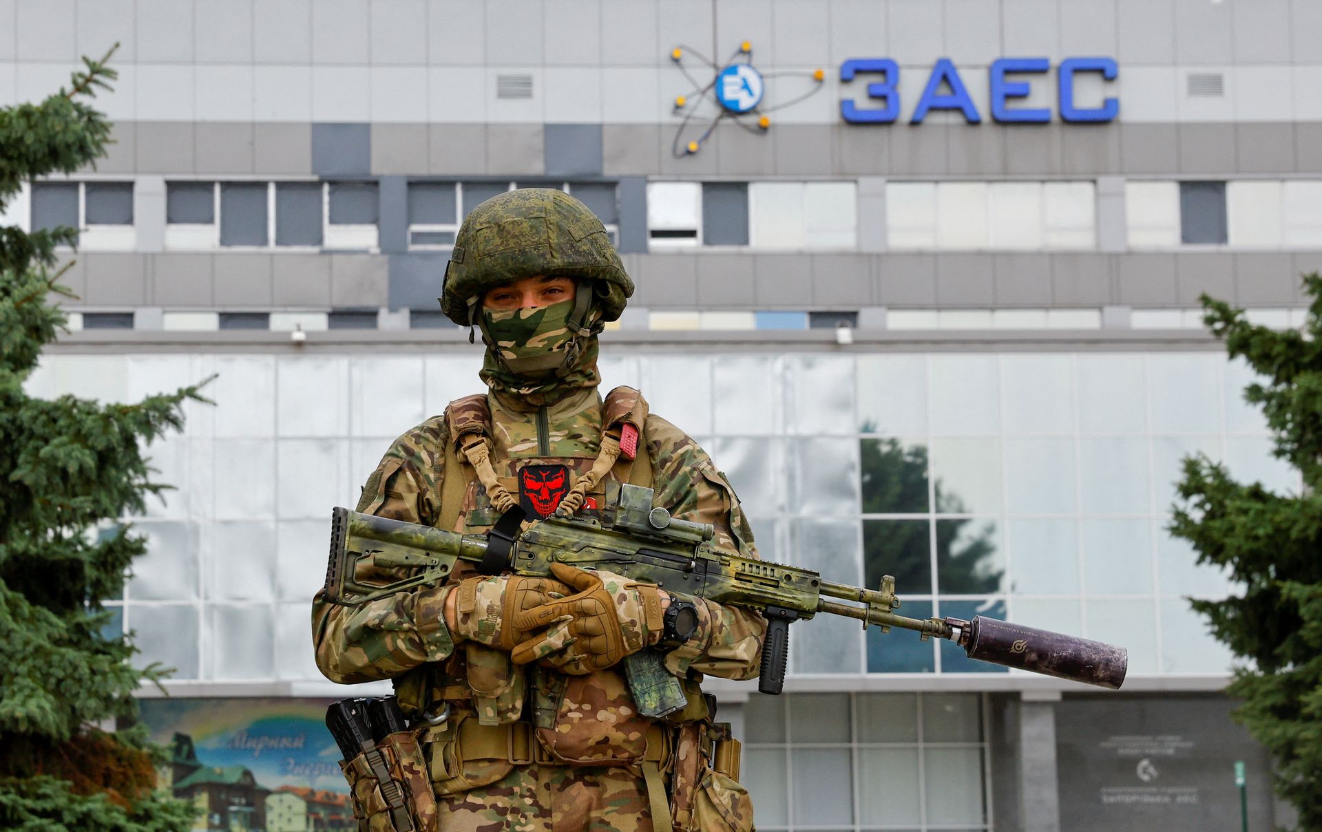 A service member stands guard near the Russian-controlled Zaporizhzhia Nuclear Power Plant following the arrival of the International Atomic Energy Agency (IAEA) expert mission in the course of Ukraine-Russia conflict outside Enerhodar in the Zaporizhzhia region, Ukraine, September 1, 2022. REUTERS/Alexander Ermochenko/File Photo