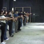 People shoot air soft guns at a private civilian training organization named Polar Light Training in New Taipei City, Taiwan on June 21, 2022. While an invasion doesn’t appear imminent, China’s recent large-scale military exercises in response to a visit by U.S. House Speaker Nancy Pelosi to Taiwan have made the government in Taipei more aware than ever of the hard power behind Beijing’s rhetoric about bringing the self-ruled island under its control. Experts said that civilian defense and reserve forces have an important deterrent effect, showing a potential aggressor that the risks of invasion are high. (AP Photo/Wu Taijing)