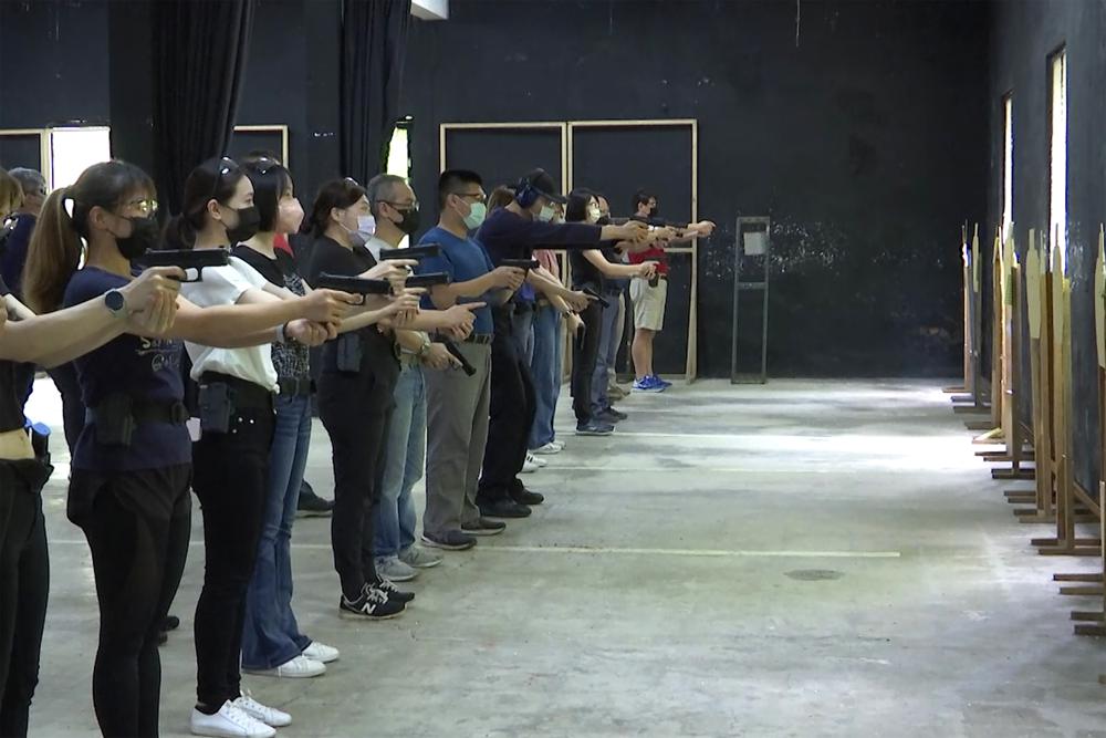 People shoot air soft guns at a private civilian training organization named Polar Light Training in New Taipei City, Taiwan on June 21, 2022. While an invasion doesn’t appear imminent, China’s recent large-scale military exercises in response to a visit by U.S. House Speaker Nancy Pelosi to Taiwan have made the government in Taipei more aware than ever of the hard power behind Beijing’s rhetoric about bringing the self-ruled island under its control. Experts said that civilian defense and reserve forces have an important deterrent effect, showing a potential aggressor that the risks of invasion are high. (AP Photo/Wu Taijing)