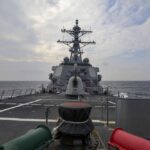 In this photo provided by U.S. Navy, The guided-missile destroyer USS Higgins (DDG 76) conducts a routine Taiwan Strait transit Sept. 20, 2022. China toned down its rhetoric on Taiwan on Wednesday, Sept. 21, saying it is inevitable that the self-governing island comes under its control but that it would promote efforts to achieve that peacefully. The comments came one day after the U.S. and Canadian navies sailed through the strait between China and Taiwan. (Mass Communication Specialist 1st Class Donavan K. Patubo/U.S.Navy via AP)