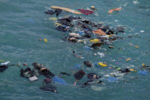 EDS NOTE: GRAPHIC CONTENT – EDITORS NOTE GRAPHIC CONTENTS. Bodies are seen floating amongst debris after a sailboat carrying migrants smashed into rocks and sank off the island of Kythira, southern Greece, Thursday, Oct. 6, 2022. Residents of a Greek island pulled shipwrecked migrants to safety up steep cliffs in dramatic rescues after two boats sank in Greek waters, leaving at least 21 people dead and many still missing. (AP Photo/Thanassis Stavrakis)