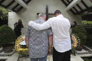 Relatives pay their respect for the victims of the Bali bombings during the commemoration of the 20th anniversary of the attack that killed 202 people, mostly foreign tourists, including 88 Australians and seven Americans, at the Australian Consulate in Denpasar, Bali, Indonesia on Wednesday, Oct. 12, 2022. Services were held simultaneously in several places in Australia and at Bali’s Australian Consulate in the city of Denpasar, where Australian survivors and relatives of the deceased were among the 200 in attendance to pay tribute to their loved ones who died in the most popular tourist area on the island two decades ago. (AP Photo/Firdia Lisnawati, Pool)