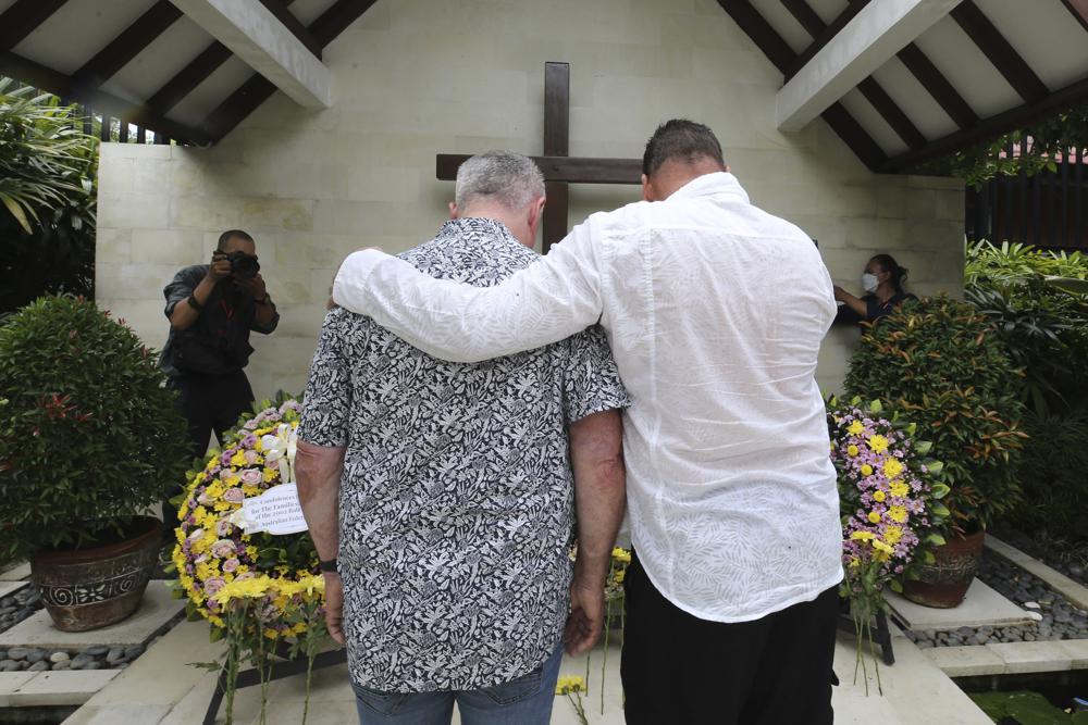 Relatives pay their respect for the victims of the Bali bombings during the commemoration of the 20th anniversary of the attack that killed 202 people, mostly foreign tourists, including 88 Australians and seven Americans, at the Australian Consulate in Denpasar, Bali, Indonesia on Wednesday, Oct. 12, 2022. Services were held simultaneously in several places in Australia and at Bali’s Australian Consulate in the city of Denpasar, where Australian survivors and relatives of the deceased were among the 200 in attendance to pay tribute to their loved ones who died in the most popular tourist area on the island two decades ago. (AP Photo/Firdia Lisnawati, Pool)