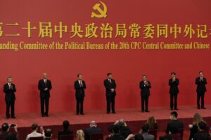 FILE – New members of the Politburo Standing Committee, from left, Li Xi, Cai Qi, Zhao Leji, President Xi Jinping, Li Qiang, Wang Huning, and Ding Xuexiang are introduced at the Great Hall of the People in Beijing on Oct. 23, 2022. The world faces the prospect of more tension with China over trade, security and human rights after Xi Jinping awarded himself a third five-year term on Oct. 23, 2022 as leader of the ruling Communist Party. (AP Photo/Ng Han Guan, File)
