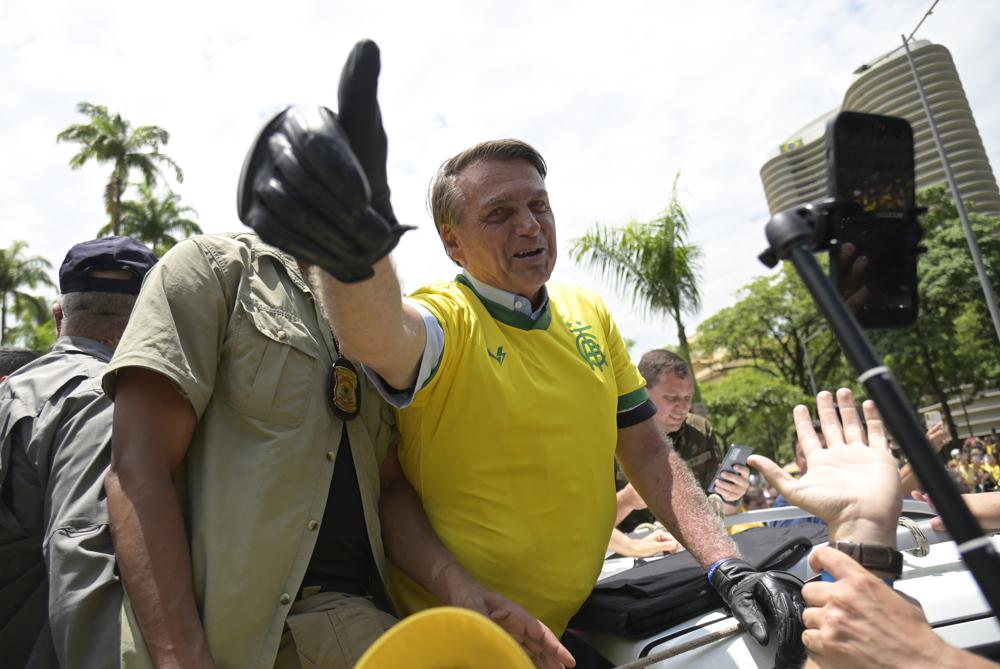 Brazil’s President Jair Bolsonaro flashes a thumbs up as he greets supporters during a campaign rally in Praca da Liberdade or Liberty Square, in Belo Horizonte, Brazil, Saturday, Oct. 29, 2022. Bolsonaro is facing former President Luiz Inacio Lula da Silva in a runoff election set for Oct. 30. (AP Photo/Yuri Laurindo)
