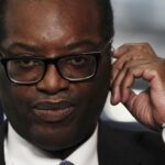 Chancellor of the Exchequer Kwasi Kwarteng speaking to the media ahead of the Conservative Party annual conference at the International Convention Centre in Birmingham. Picture date: Monday October 3, 2022. The British government has dropped plans to cut income tax for top earners, part of a package of unfunded cuts that sparked turmoil on financial markets and sent the pound to record lows. (Aaron Chown/PA via AP)