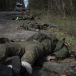 EDS NOTE: GRAPHIC CONTENT – Dead bodies of Russian servicemen lie on the ground in recently recaptured town of Lyman, Ukraine, Monday, Oct. 3, 2022. (AP Photo/Evgeniy Maloletka)
