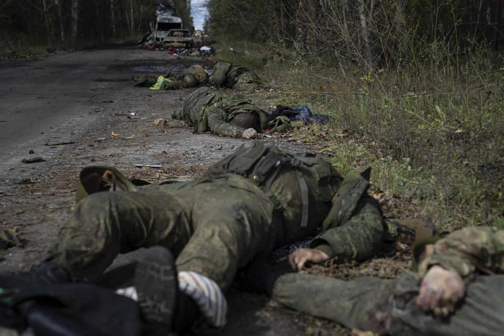 EDS NOTE: GRAPHIC CONTENT – Dead bodies of Russian servicemen lie on the ground in recently recaptured town of Lyman, Ukraine, Monday, Oct. 3, 2022. (AP Photo/Evgeniy Maloletka)