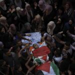 Palestinian mourners carry the body of Fayez Damdoum, during his funeral in the West Bank village of Azariyah, Saturday, Oct. 1, 2022. Israel’s paramilitary border police said forces shot a protester who attempted to throw a firebomb at them as they came to disperse a demonstration. It said demonstrators threw stones and explosives at them. The Palestinian Health Ministry identified the dead youth as 18-year-old Fayez Damdoum. (AP Photo/Mahmoud Illean)