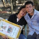 Tukta Wongsila grieves with her father Saart as holds her daughter Siriprapa “Plai Fon” Prasertsuk’s picture, one of the many victims of a mass killing attack in the rural town of Uthai Sawan, north eastern Thailand, Friday, Oct. 7 , 2022. A former police officer burst into a day care center in northeastern Thailand on Thursday, killing dozens of preschoolers and teachers before shooting more people as he fled. (AP Photo/Sakchai Lalit)