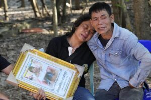 Tukta Wongsila grieves with her father Saart as holds her daughter Siriprapa “Plai Fon” Prasertsuk’s picture, one of the many victims of a mass killing attack in the rural town of Uthai Sawan, north eastern Thailand, Friday, Oct. 7 , 2022. A former police officer burst into a day care center in northeastern Thailand on Thursday, killing dozens of preschoolers and teachers before shooting more people as he fled. (AP Photo/Sakchai Lalit)