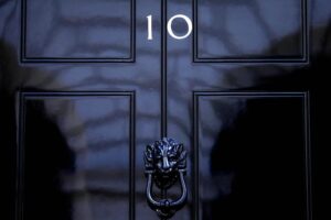 FILE – The door to 10 Downing Street in London, Friday, July 8, 2022. Under Britain’s parliamentary system, the public never actually votes for its prime minister. Instead, voters tick the box for a representative from their local area, who then becomes one of Britain’s 650 Members of Parliament. The party that wins a majority forms a government and puts their leader into the prime minister’s seat. (AP Photo/Frank Augstein, File)