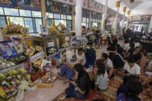 Relatives of the victims of a mass killing attack pray during a Buddhist ceremony at Wat Rat Samakee temple in the rural town of Uthai Sawan, north eastern Thailand, Saturday, Oct. 8, 2022. A former police officer burst into a day care center in northeastern Thailand on Thursday, killing dozens of preschoolers and teachers before shooting more people as he fled. (AP Photo/Wason Wanichakorn)