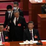 Former President Hu Jintao walks past Chinese President Xi Jinping, right, and Premier Li Keqiang during the closing ceremony of the 20th National Congress of China’s ruling Communist Party at the Great Hall of the People in Beijing, Saturday, Oct. 22, 2022. (AP Photo/Ng Han Guan)