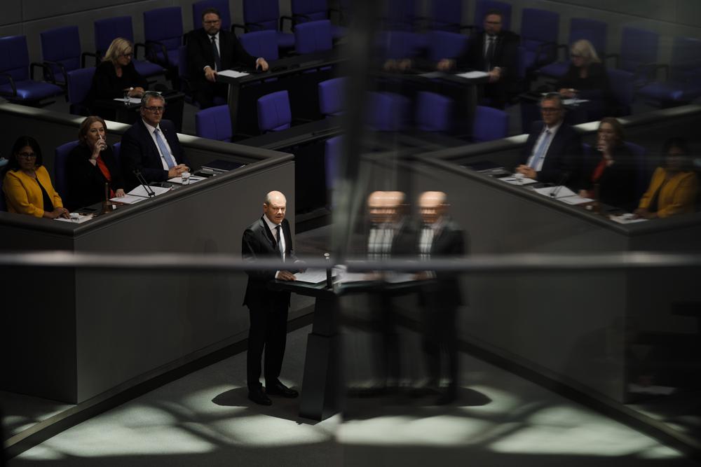 German Chancellor Olaf Scholz addresses the German parliament Bundestag ahead of an EU summit at the Reichstag building in Berlin, Germany, Thursday, Oct. 20, 2022. (AP Photo/Markus Schreiber)