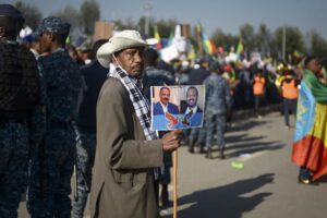 A man holds a placard showing Eritrea’s President Isaias Afwerki, left, and Ethiopia’s President Abiy Ahmed, right, at a rally organized by the city administration against what they say is interference by outsiders in the country’s internal affairs and against the Tigray People’s Liberation Front (TPLF), the party of Tigray’s fugitive leaders, in the capital Addis Ababa, Ethiopia Saturday, Oct. 22, 2022. The demonstrations were staged ahead of the expected start of peace talks in South Africa next week between the warring parties, with the U.S. saying Friday it supports the African Union’s efforts to mediate talks to stop fighting in Tigray. (AP Photo)