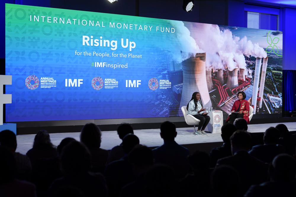 Climate activist Vanessa Nakate of Uganda, left, speaks alongside moderator Sabina Bhatia at the 2022 annual meeting of the International Monetary Fund and the World Bank Group, Monday, Oct. 10, 2022, in Washington. (AP Photo/Patrick Semansky)