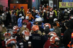 Rescue workers try to carry victims on the street near the scene, in Seoul, South Korea, Sunday, Oct. 30, 2022. South Korean officials say at least 120 people were killed and 100 more were injured as they were crushed by a large crowd pushing forward on a narrow street during Halloween festivities in the capital of Seoul. Choi Seong-beom, chief of Seoul’s Yongsan fire department, said the death toll could rise, saying that an unspecified number among the injured were in critical conditions. (AP Photo/Lee Jin-man)