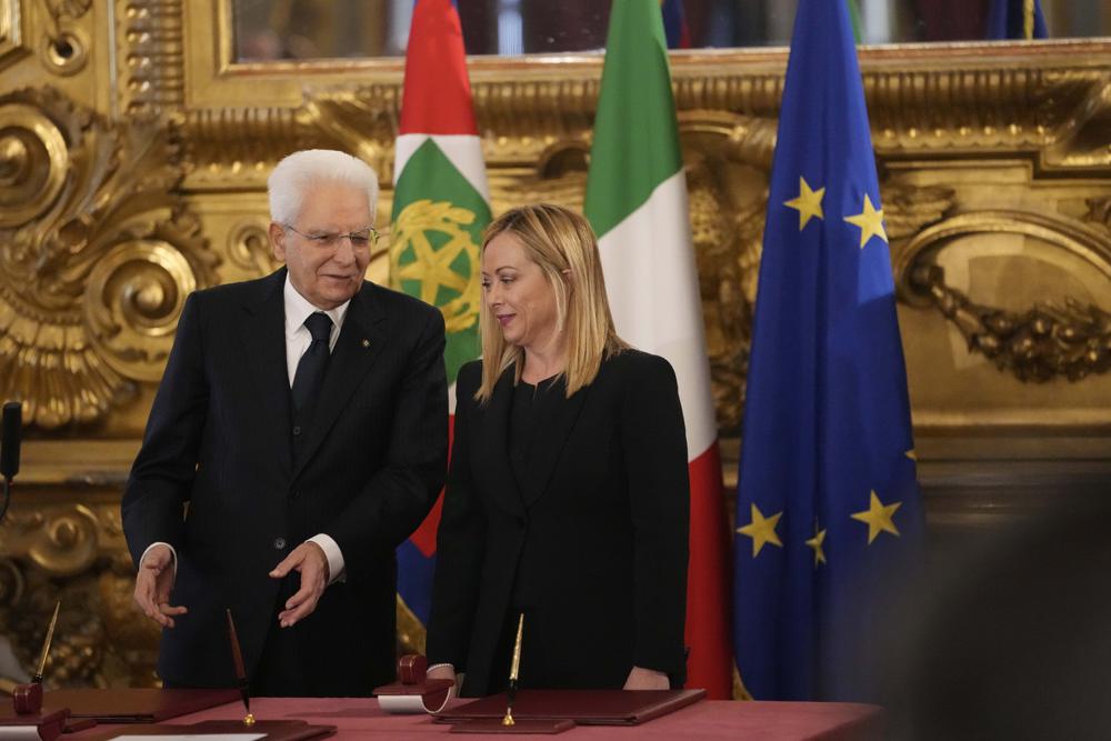Italian President Sergio Mattarella is flanked by newly appointed Italian Premier Giorgia Meloni during the swearing in ceremony at Quirinal presidential palace in Rome, Saturday, Oct. 22, 2022, as Italy’s first far-right-led government since the end of World War II takes office. (AP Photo/Alessandra Tarantino)
