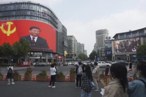 Chinese President Xi Jinping is seen at the end of the Chinese Communist Party’s 20th Party Congress on a giant screen a commercial district of Hangzhou in eastern China’s Zhejiang province on Sunday, Oct 23, 2022. China’s economic growth accelerated in the latest quarter but still was among the slowest in decades as the country wrestled with repeated closures of cities to fight virus outbreaks. (Chinatopix via AP)