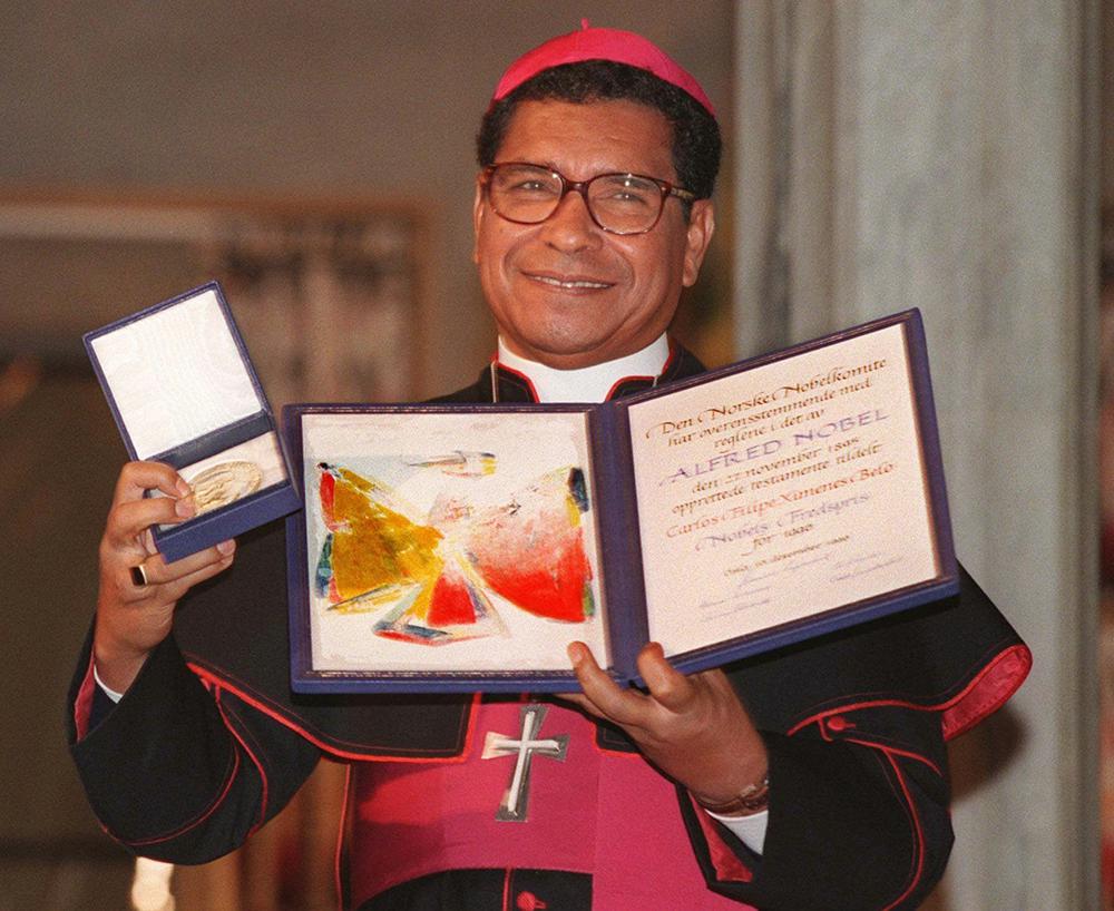 FILE – Nobel Peace Prize laureate, East Timor bishop Carlos Filipe Ximenes Belo displays his certificate and medal during the Nobel ceremony at the Oslo townhall, on Dec. 10, 1996. Belo has been accused in a Dutch magazine article of sexually abusing boys in East Timor in the 1990s, rocking the Catholic Church in the impoverished nation and forcing officials at the Vatican and his religious order to scramble to provide answers. (AP Photo/Bjoern Sigurdsoen, File)