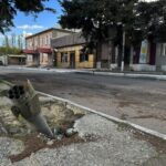 A part of a rocket sits wedged in the ground on a street in the recaptured town of Lyman, Ukraine, Friday, Oct. 7, 2022. Ukrainian authorities are just beginning to sift through the wreckage of the devastated city of Lyman in eastern Ukraine as they assess the humanitarian toll, and possibility of war crimes, from a months-long Russian occupation. (AP Photo/Justin Spike)